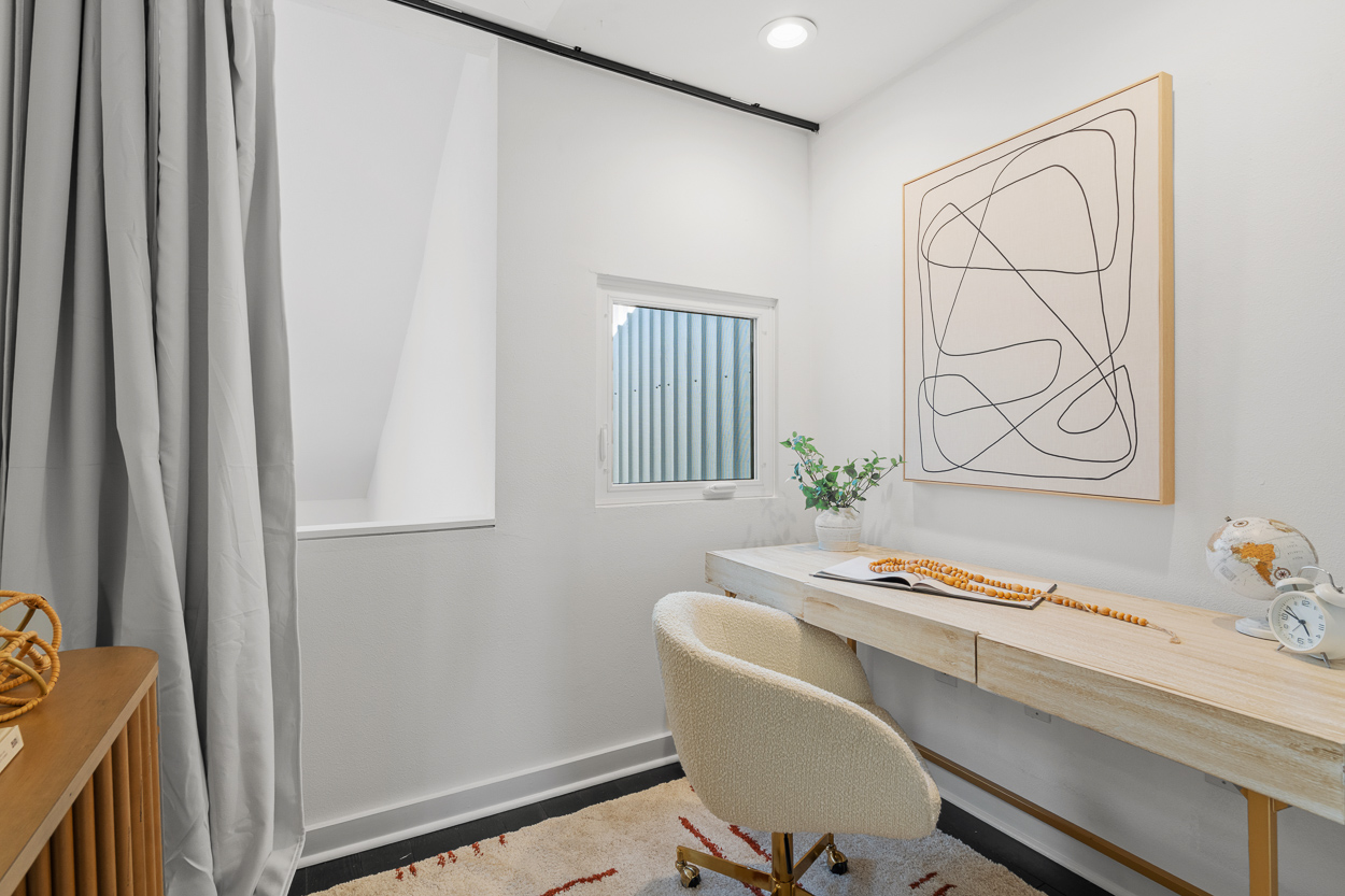 Primary suite with white oak hardwood floors and lofted home office at 930 Memorial Drive