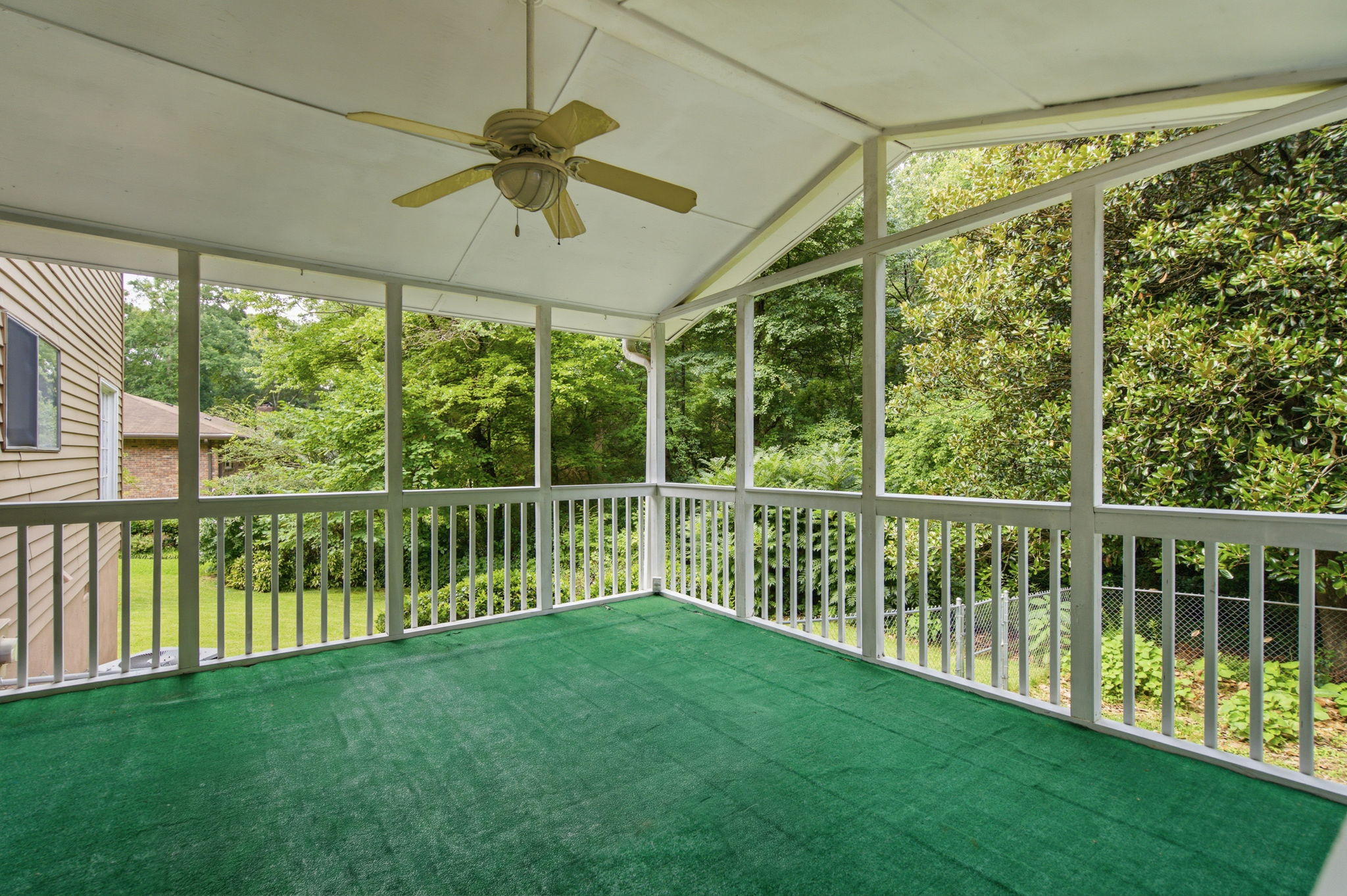 screened porch with vaulted ceiling overlooking wooded lot at 471 Surrey Place Marietta